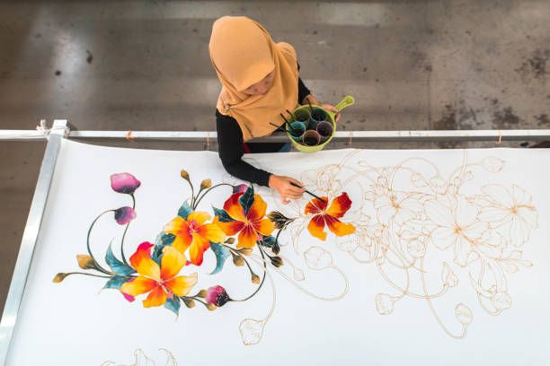 istock Woman painting in a batik workshop 994288418