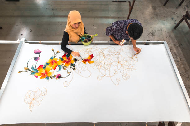istock Coworkers painting in a batik workshop 994288436