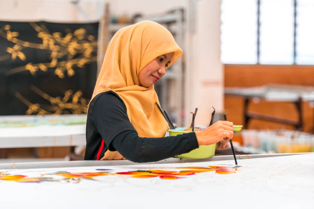 istock Woman painting in a batik workshop 994288442