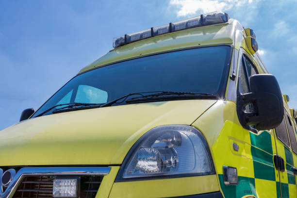 Yellow and green British Ambulance on a sunny day stock photo