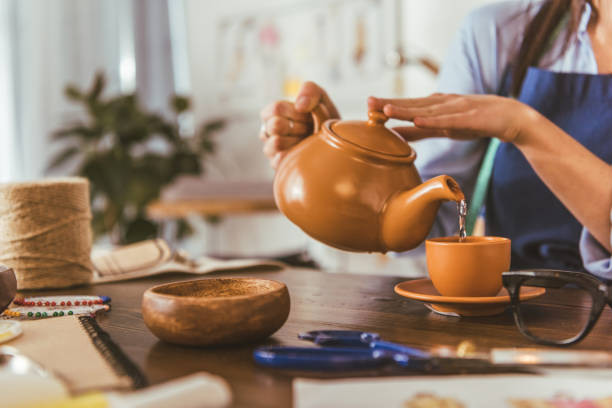 istock cropped image of seamstress pouring tea in cup during lunch 994291736