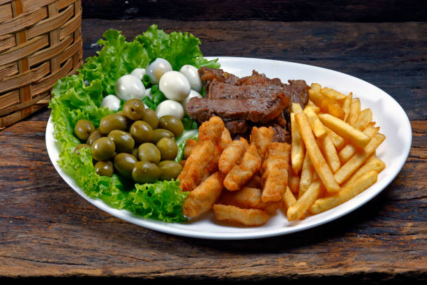 istock Plate with Assorted Appetizers, Olive, Meat, Quail Egg, French Fries 994294106