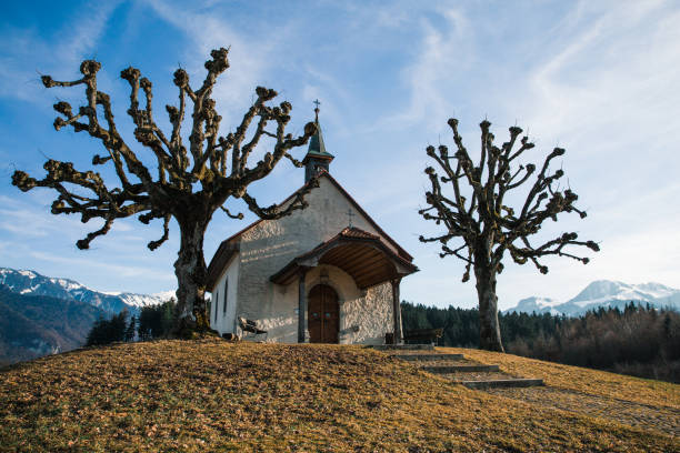 Small Swiss Chapel in Winter with Mountains in the Background Small Swiss Chapel in Winter with Mountains in the Background bulle stock pictures, royalty-free photos & images