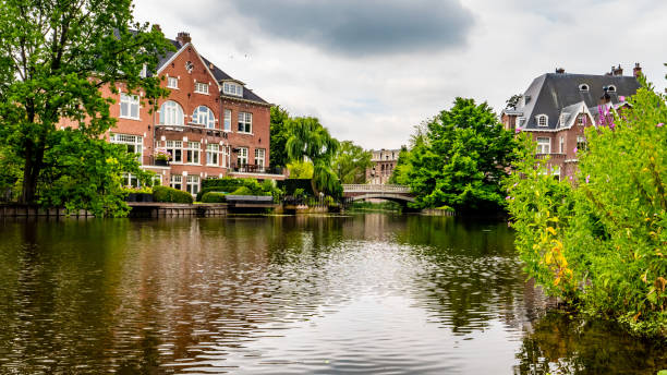 istock old mansion with little bridge, amsterdam on a river 994295016