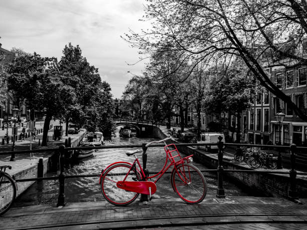 istock red bicycle standing on a bridge, black and white 994297382