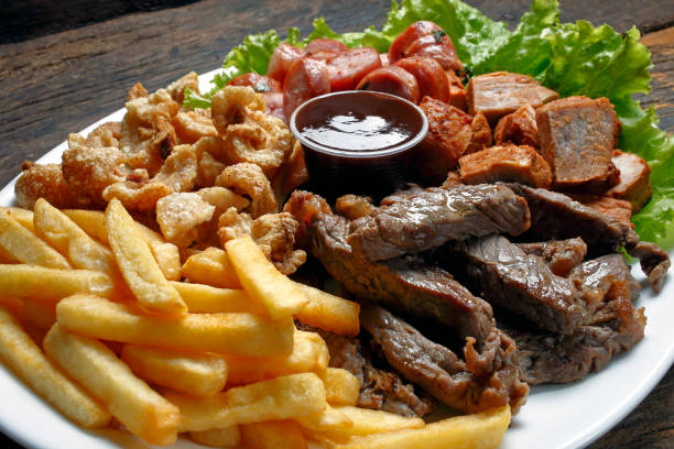istock Snacks with fries, crackers, meat, pork, sausage, babercue sauce 994297996