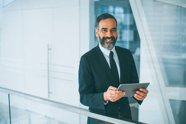 istock Middle age businessman with tablet in the office 994308178