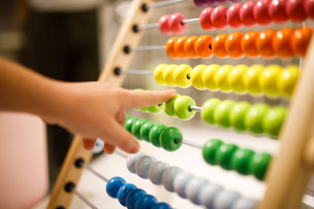 Abacus Small fingers on the colorful abacus abacus stock pictures, royalty-free photos & images