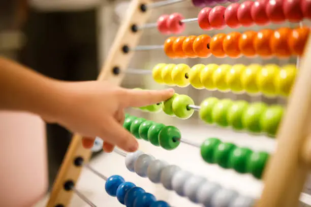 Small fingers on the colorful abacus