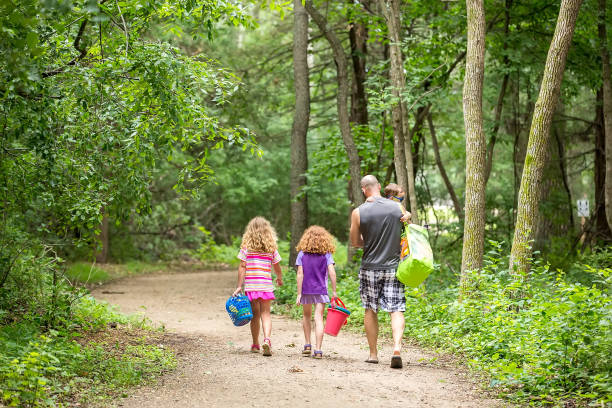 istock Father and Three Kids Walking Through Woods To Beach 994314434