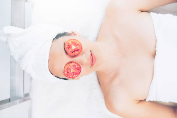 istock Woman getting eye nature treatment by tomato. 994319164
