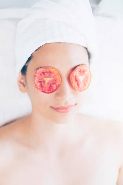 istock Woman getting eye nature treatment by tomato. 994319174