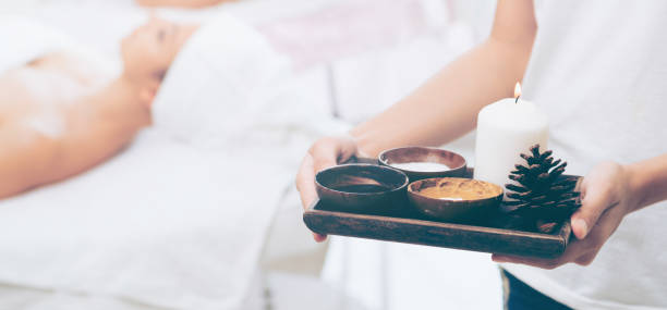 istock Massage therapist with hot spa treatment set. 994319240