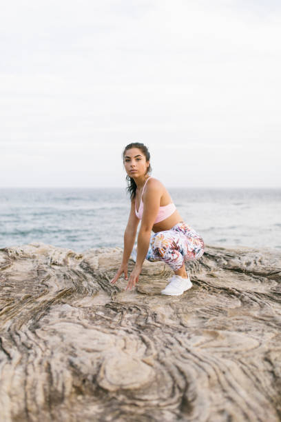 istock Cute Woman Doing Yoga Exercises on Rocks 994324518