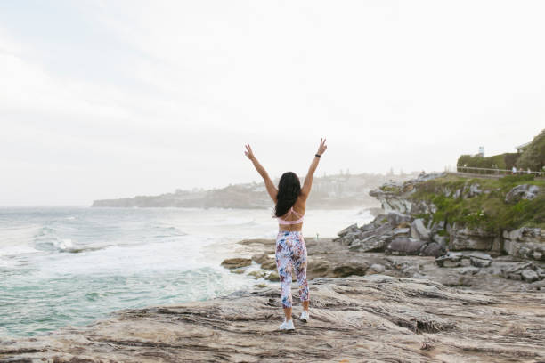 istock Fit Woman Cheering on Top of Cliff 994324588