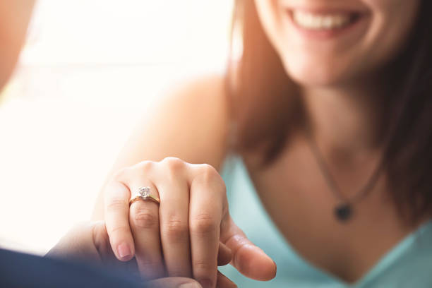 Woman is showing her diamond ring to her mum Woman is showing her diamond ring to her mum diamond ring photos stock pictures, royalty-free photos & images