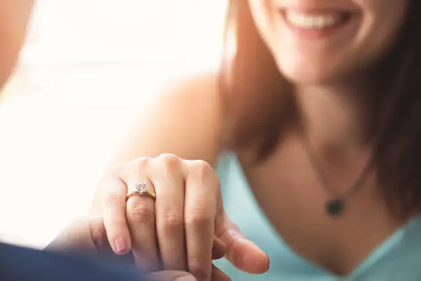 Woman is showing her diamond ring to her mum