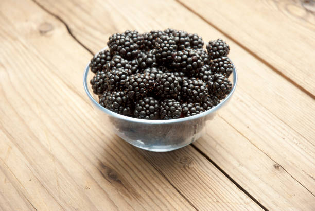 istock Blackberry on old weathered wooden table 994327900