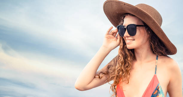 istock Woman in swimsuit posing on color background. 994328210