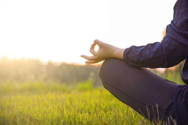 istock Close up hands woman doing yoga in park 994339022