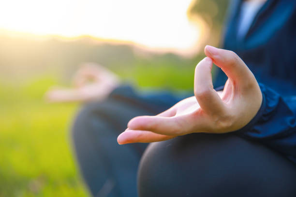 istock Close up hands woman doing yoga in park 994339032