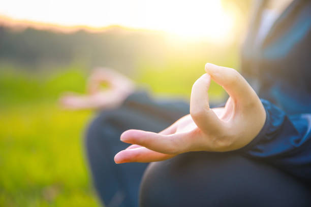 istock Close up hands woman doing yoga in park 994339048