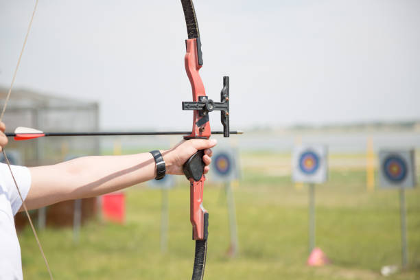 istock Closeup of bow and arrow being aimed at target 994339264