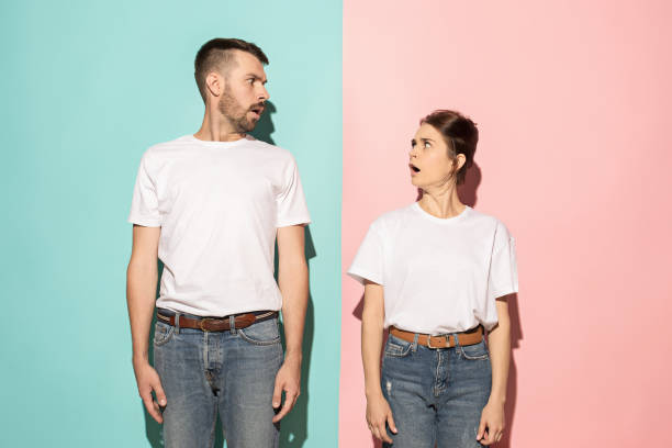 istock Wow. Doubtful pensive couple with thoughtful expression making choice against pink background 994339832