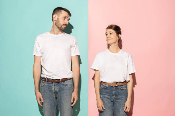 istock Let me think. Doubtful pensive couple with thoughtful expression making choice against pink background 994340800
