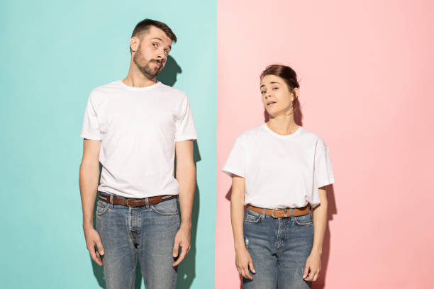 istock Let me think. Doubtful pensive couple with thoughtful expression making choice against pink background 994344032