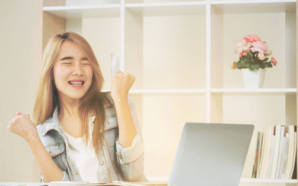 istock Excited young woman showing accomplishments. 994372102