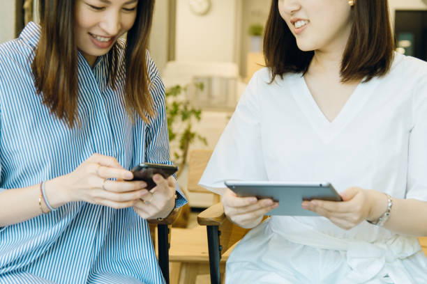 istock women working on smartphone and tablet. 994372646
