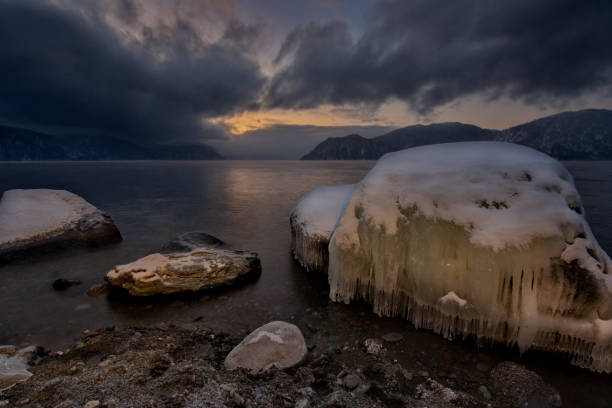 istock Winter sunset on lake Teletskoye. 994379236