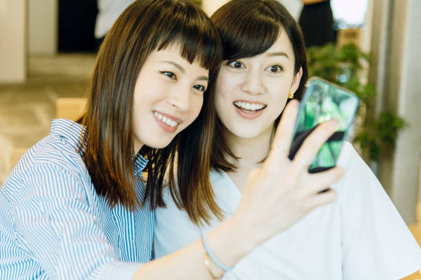 istock young women taking on selfie with smartphone. 994382032