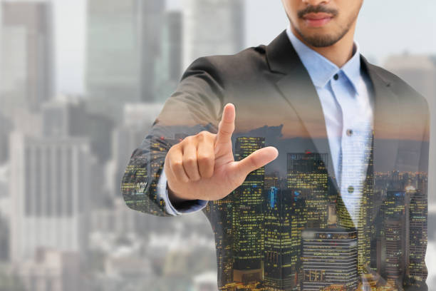 istock Double exposure businessman pointing at copy space 994383316