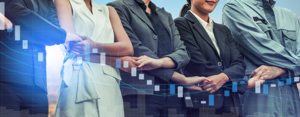istock Double exposure business people holding hands. 994383452