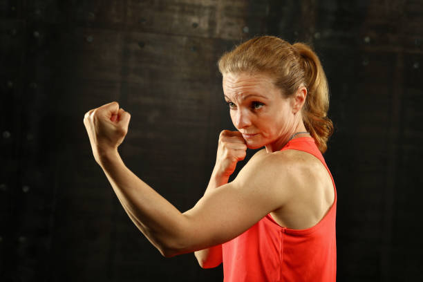 istock Side profile view of young athletic women boxing 994386464