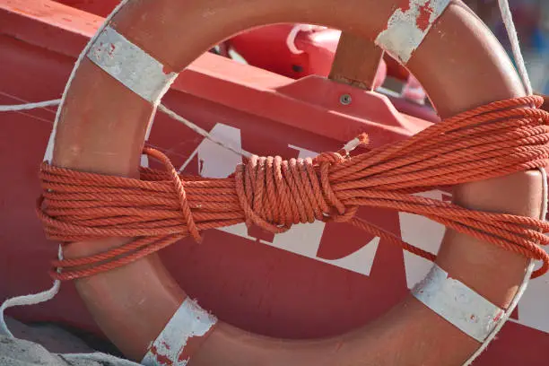 Photo of Detail of a life preserver at the sea.