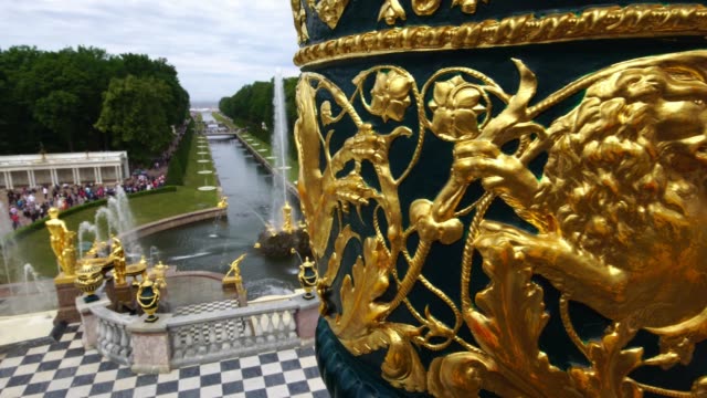 Tracking shot showing Grand Palace fountains and sculptures park in Peterhof, Saint Petersburg, Russia