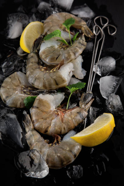 istock fresh raw king prawns with lemon and lemon balm 994394780