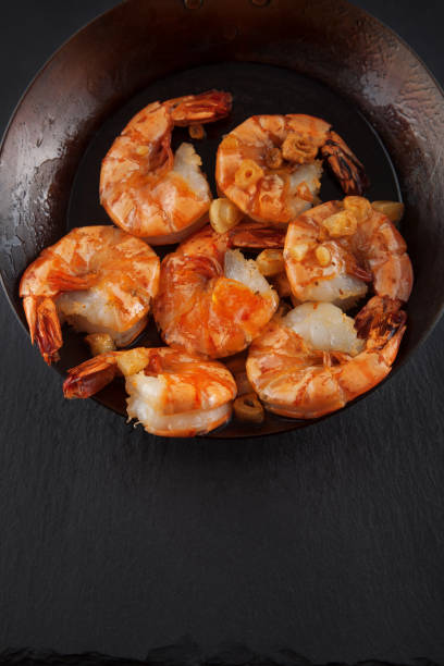 istock fresh prepared king prawns in an iron pan 994394880