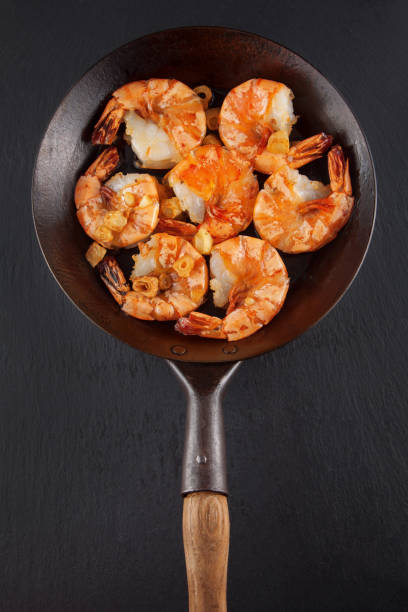 istock fresh prepared king prawns in an iron pan 994395136
