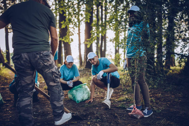 istock People cleaning together in park 994408444