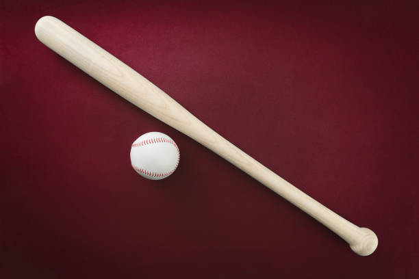 istock Baseball bat and ball on red background 994415346