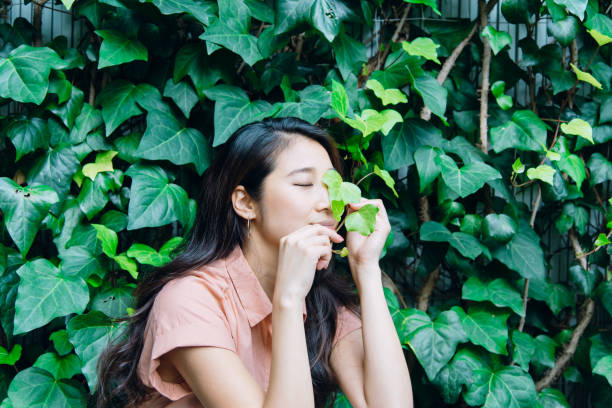 istock woman standing in front of a green wall. 994419012
