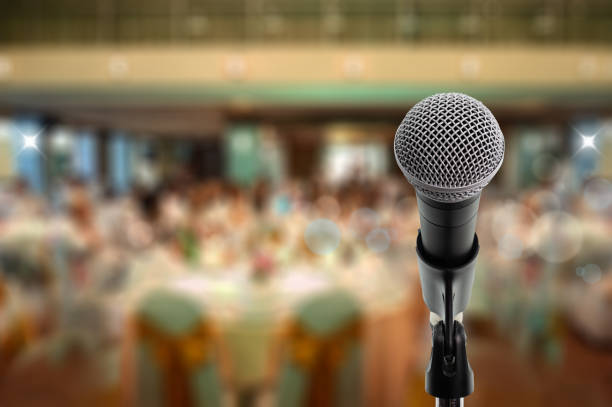 Let's talk Close up microphone  on stage in ball room. Let's talk spokesperson stock pictures, royalty-free photos & images