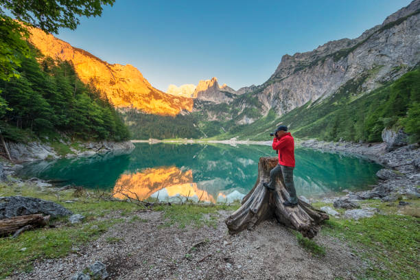 istock Photographer at Gosausee with dachstein view - European Alps 994424748
