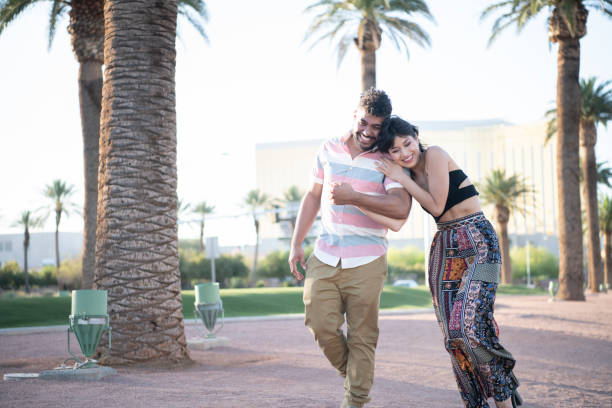 istock Cheerful young couple walking along boulevard 994424932