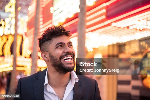 istock Cheerful young man on night out 994424948