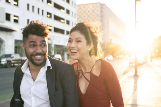 istock Young couple on boulevard laughing 994424968